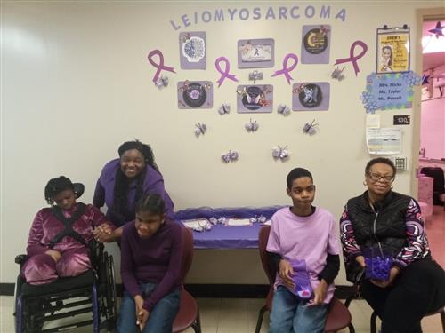 Students and parents posing in front of their door